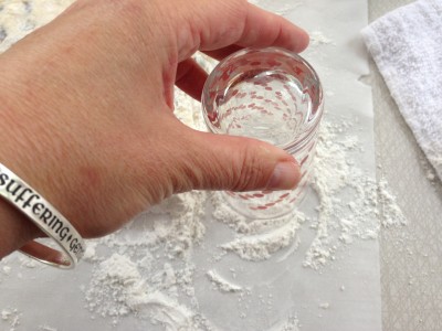 Tap glass rim in flour.