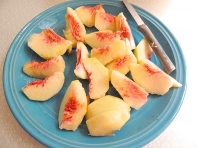 Peel and cut peaches into slices.