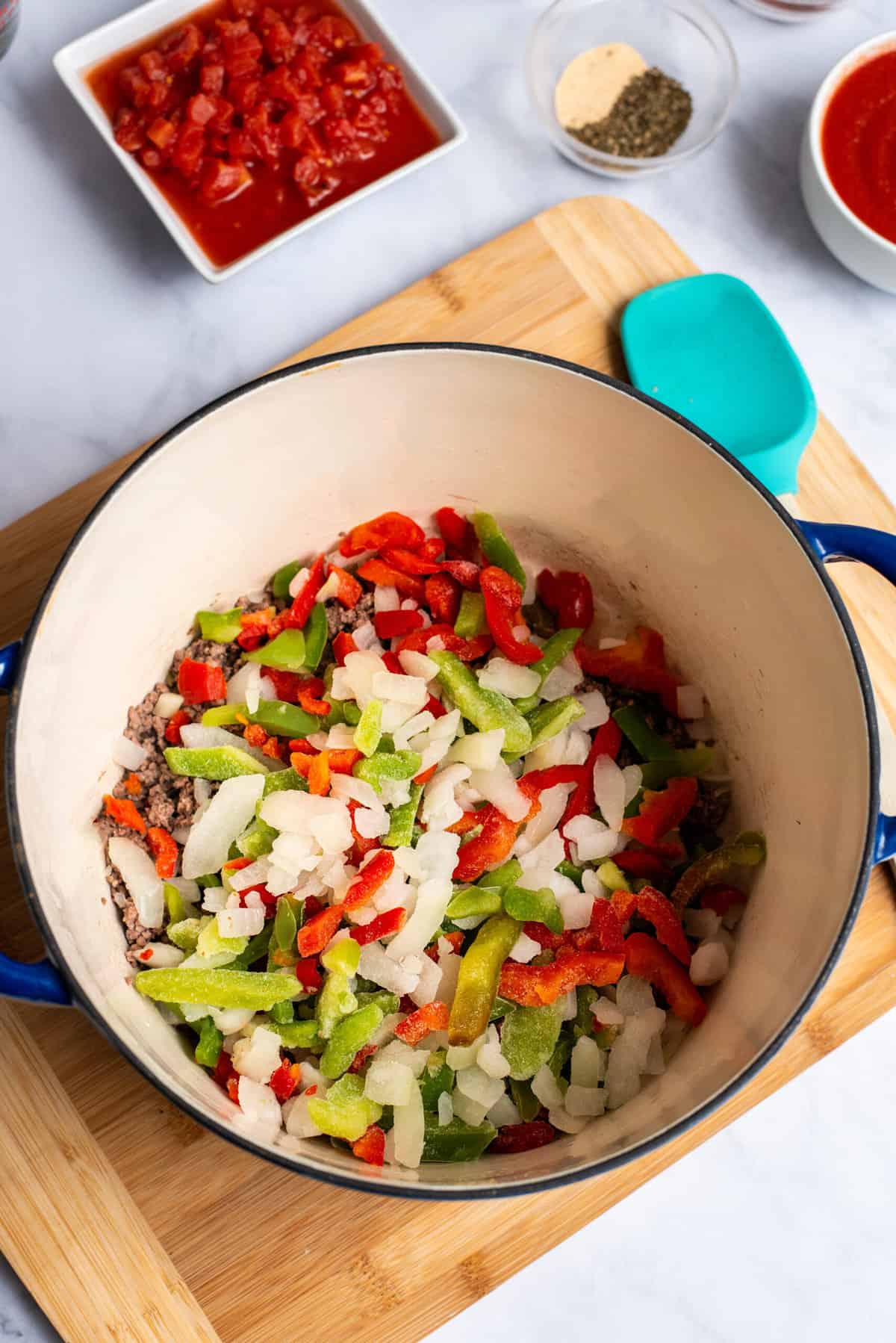 add in vegetables to ground beef