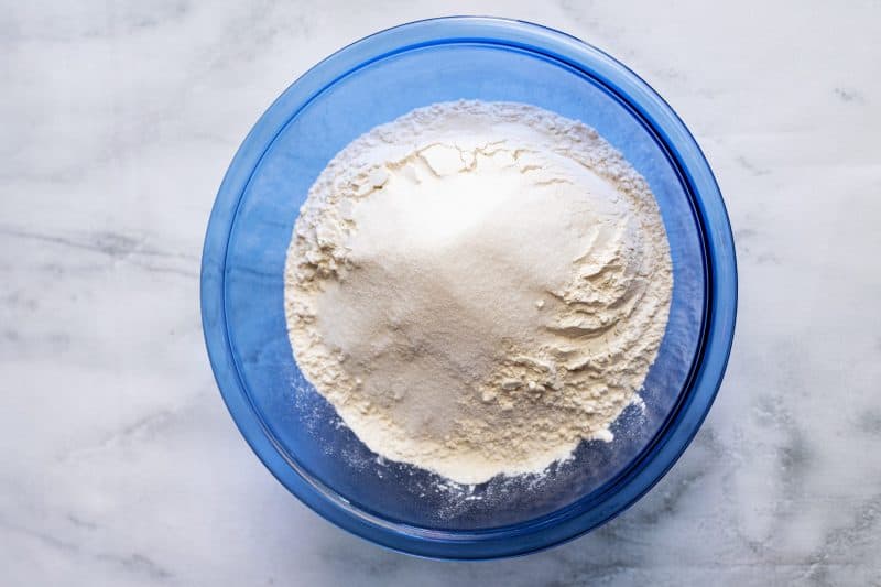 Mix together sugar and flour in separate mixing bowl.
