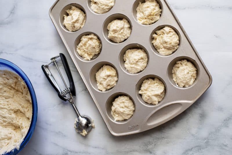 Spoon dough into greased muffin cups.