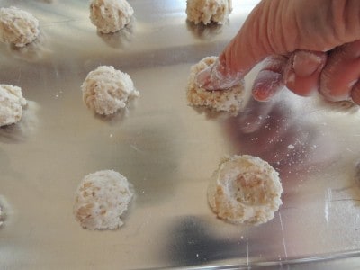 Press floured thumb into center of each cookie before baking.