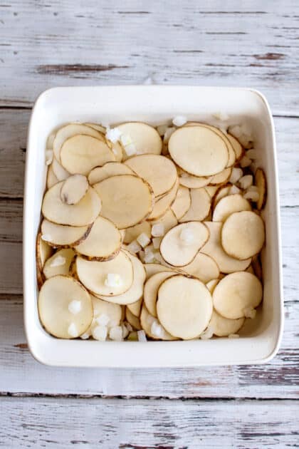 Place sliced potatoes and onion in baking dish.