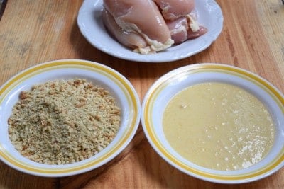 Place stuffing crumbs in one bowl and soup mixture in another.