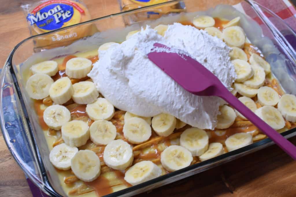 Add banana slices and entire tub of whipped topping.