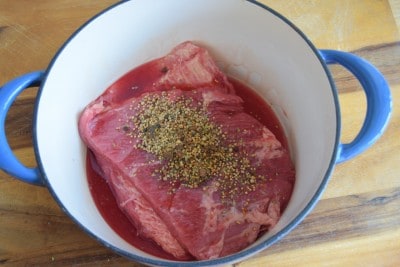 Place corned beef, seasoning, and spice in large pot.
