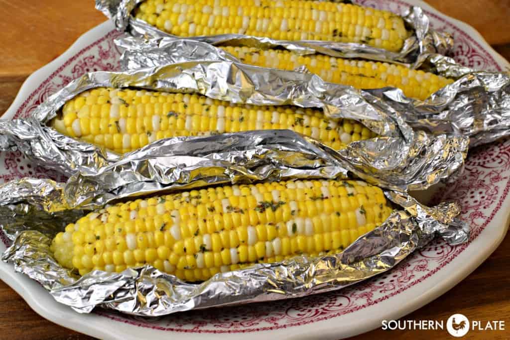 Baked corn on the cob with herb butter.