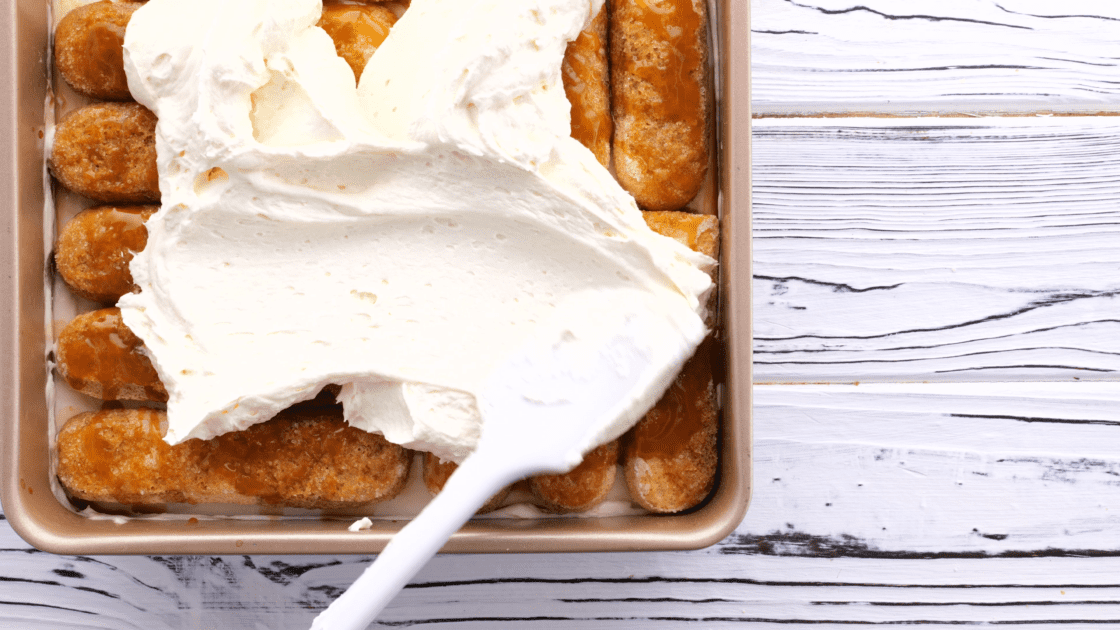 Spread cream mixture over the top of the tiramisu.