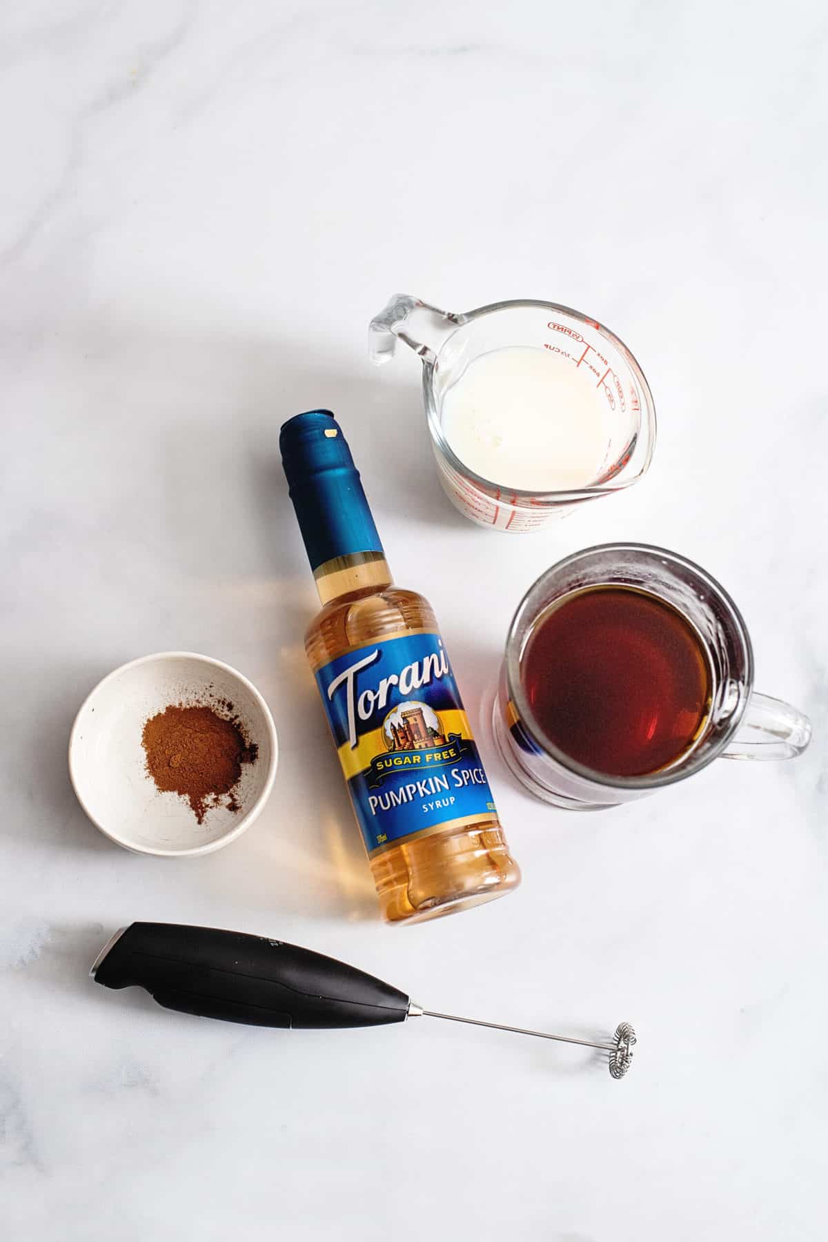 Ingredients for sugar-free pumpkin spice, featuring brewed coffee, sugar-free pumpkin spice syrup, whole milk, and cinnamon pie spice.