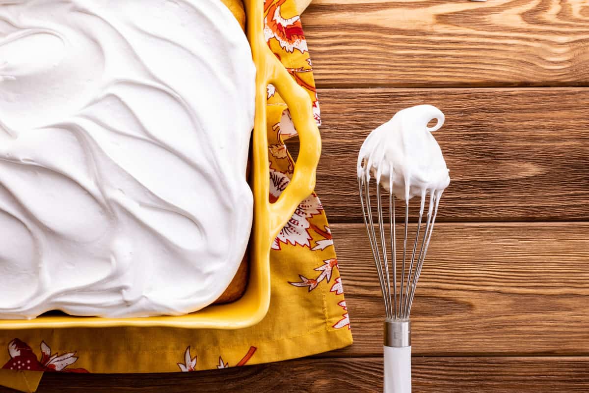 7-minute frosting covering a whisk and cake.