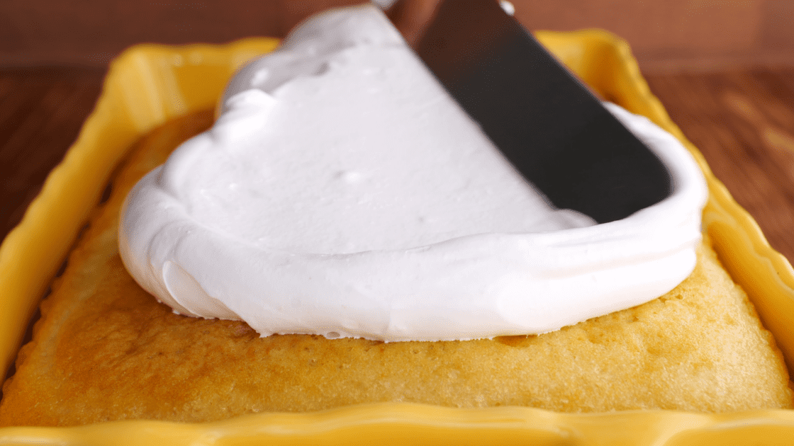 Icing sheet cake with 7-minute frosting.