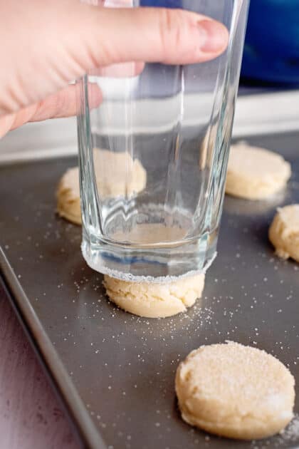 Lightly pressing the glass cup on each cookie.