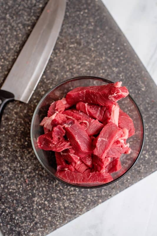 Cut beef into strips.