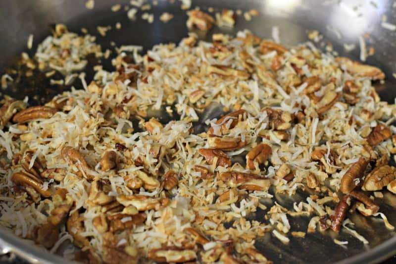 Toast coconut and pecans in skillet.