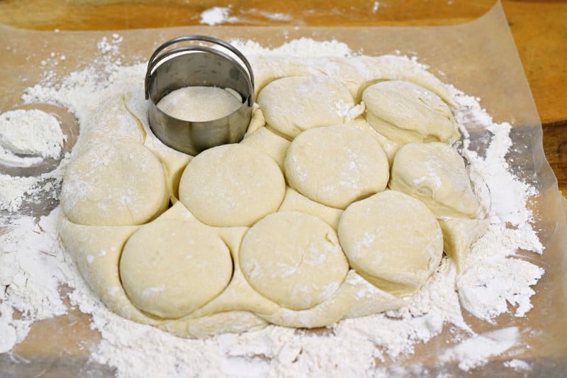 Cutting dough into rolls.