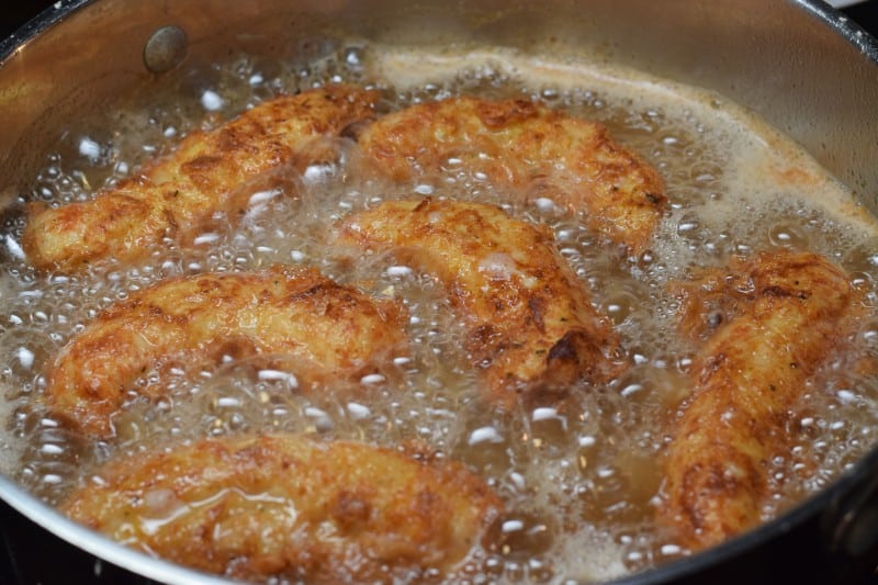 Fry chicken tenders in oil.