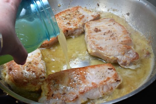 Add chicken broth to skillet.