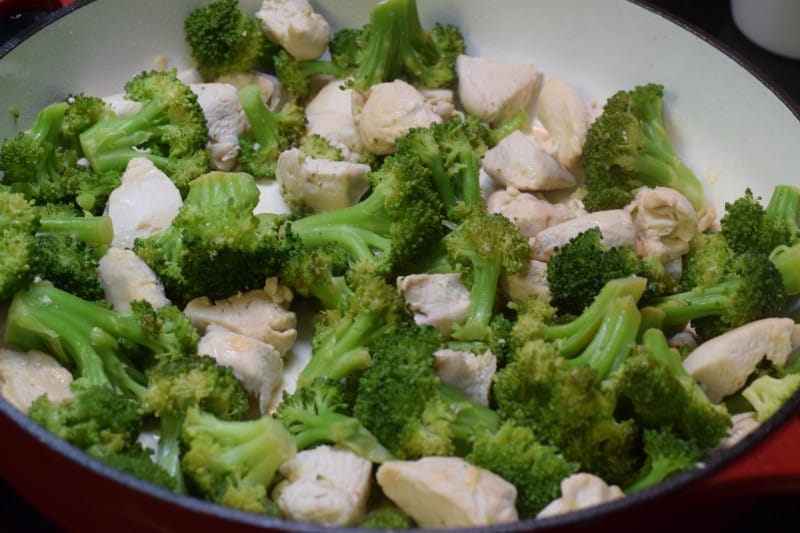 Cooked broccoli and chicken in skillet.