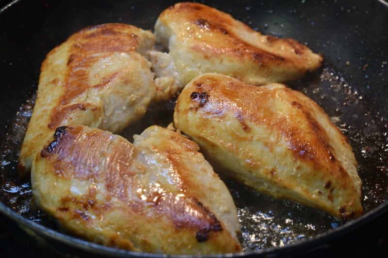 Cooked chicken breast in skillet.