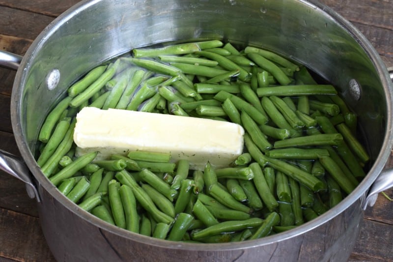green beans and butter in a pot of water