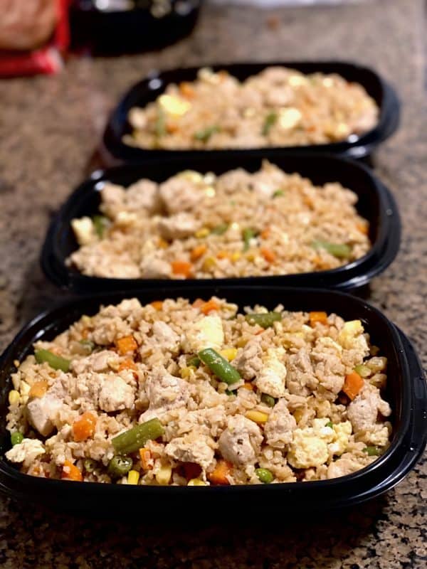 Chicken with fried rice in Tupperware-like containers for freezing.