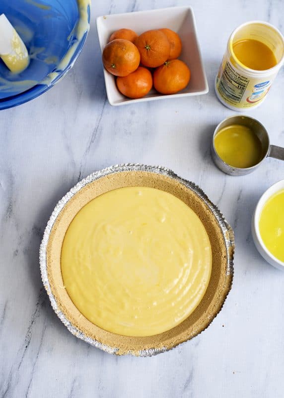 Mix together condensed milk, juice, and egg yolks in a mixing bowl and then pour into the shell.