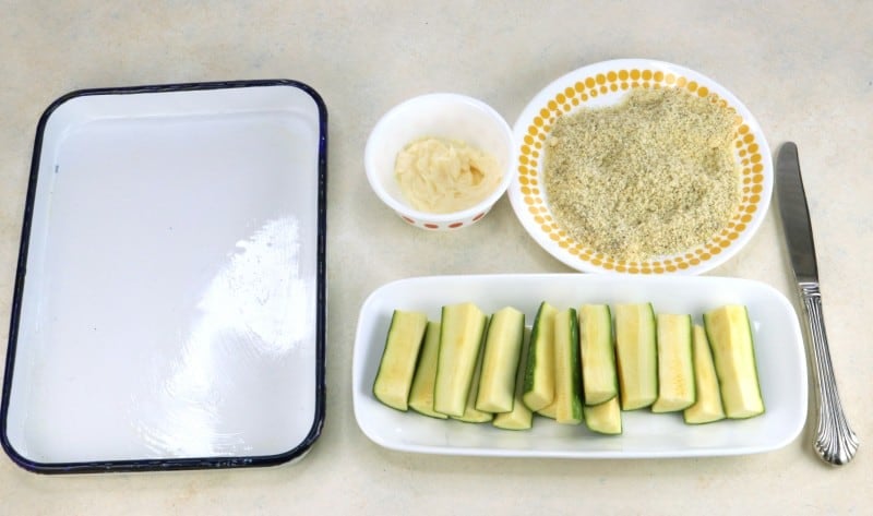 Ingredients and equipment needed for baked zucchini fries.