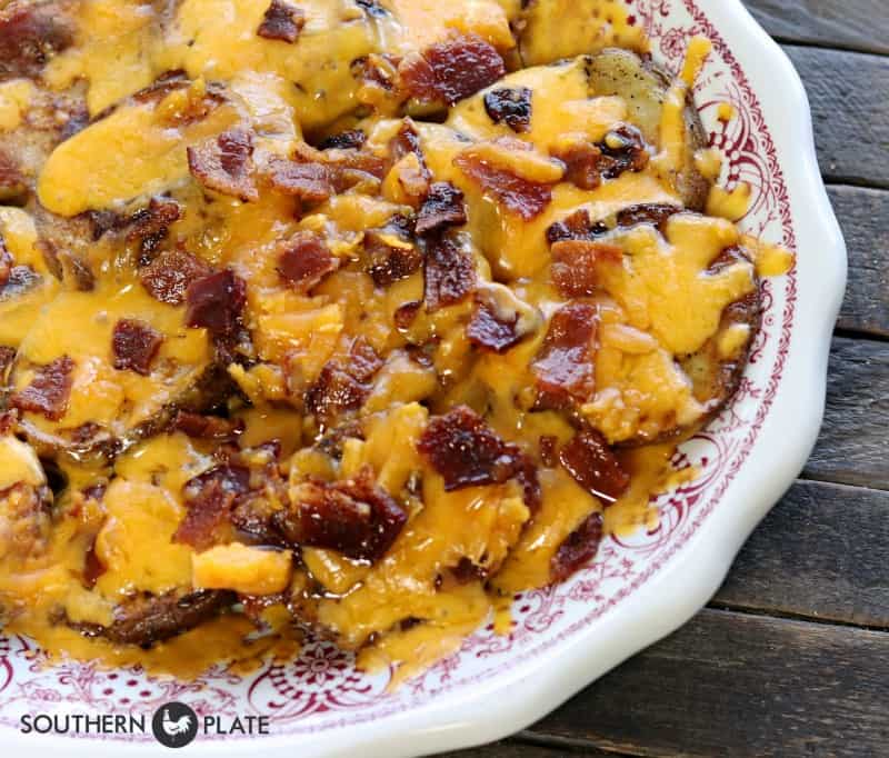 Potatoes covered in melted cheese and bacon bits.