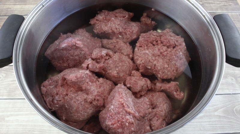 ground meat in water in a pot