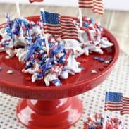 Old glory haystacks candy on a cake tray topped with patriotic sprinkles.
