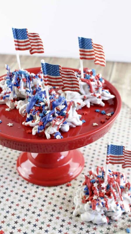 Old glory haystacks candy on a cake tray topped with patriotic sprinkles.