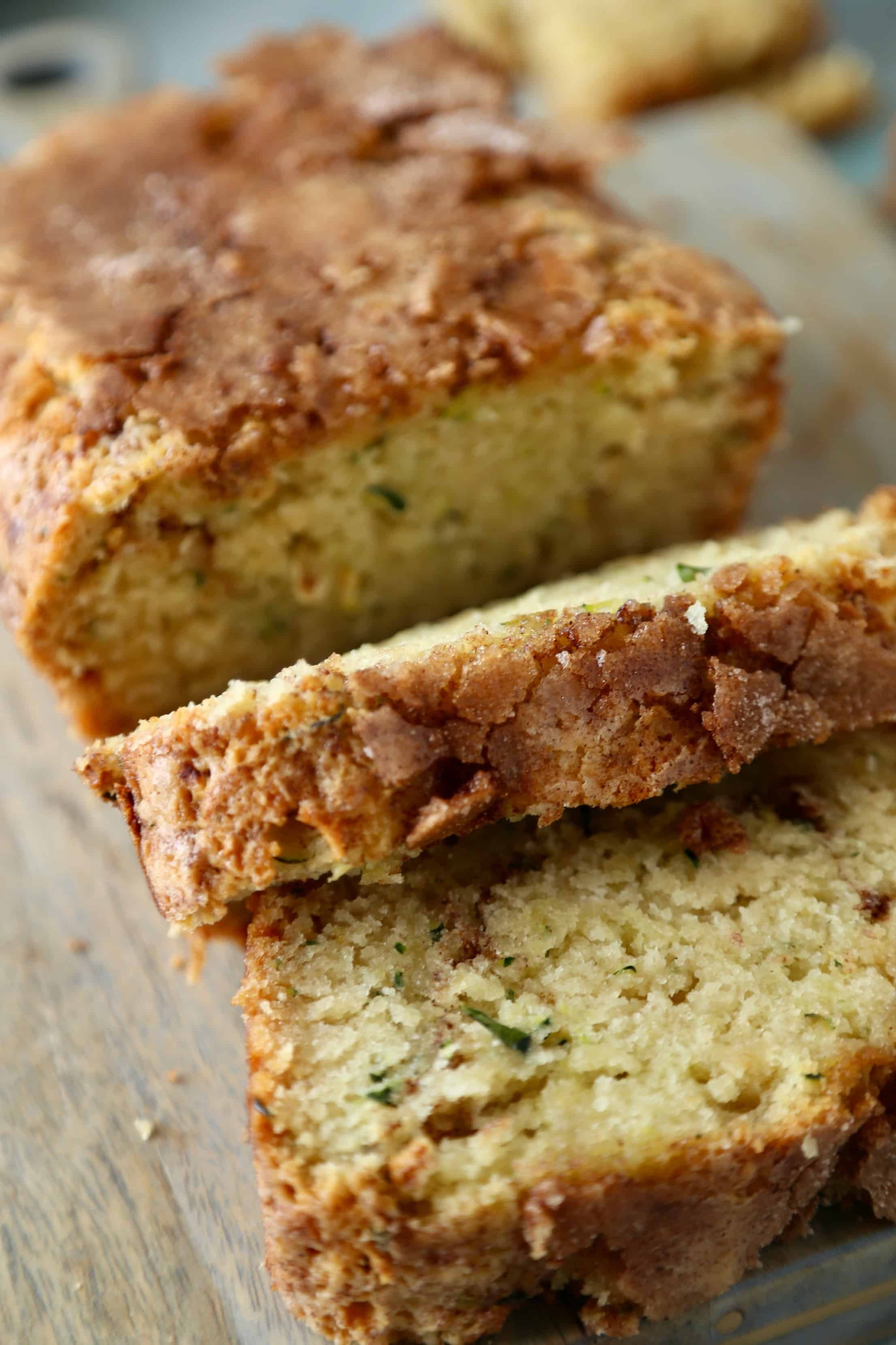 Slices of snickerdoodle zucchini bread falling off the loaf.