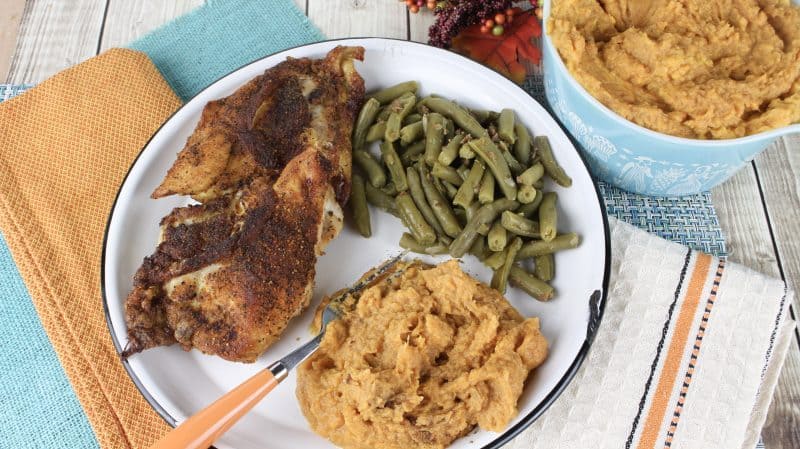 Easy Mashed Sweet Potatoes on plate with green beans and chicken.