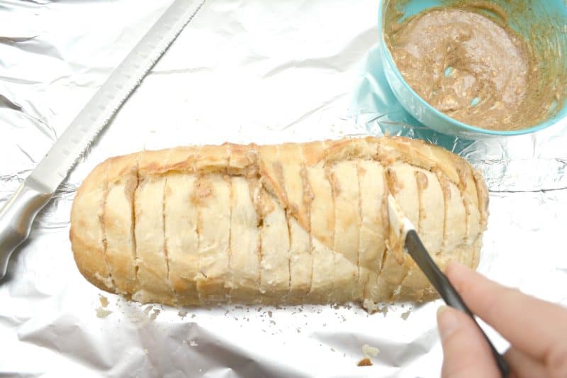 Spread butter mixture between slices in the bread loaf.