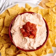 Cream cheese salsa dip surrounded by tortilla chips.