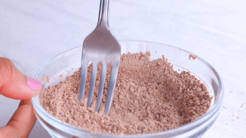 Cocoa and flour mixed with spoon.