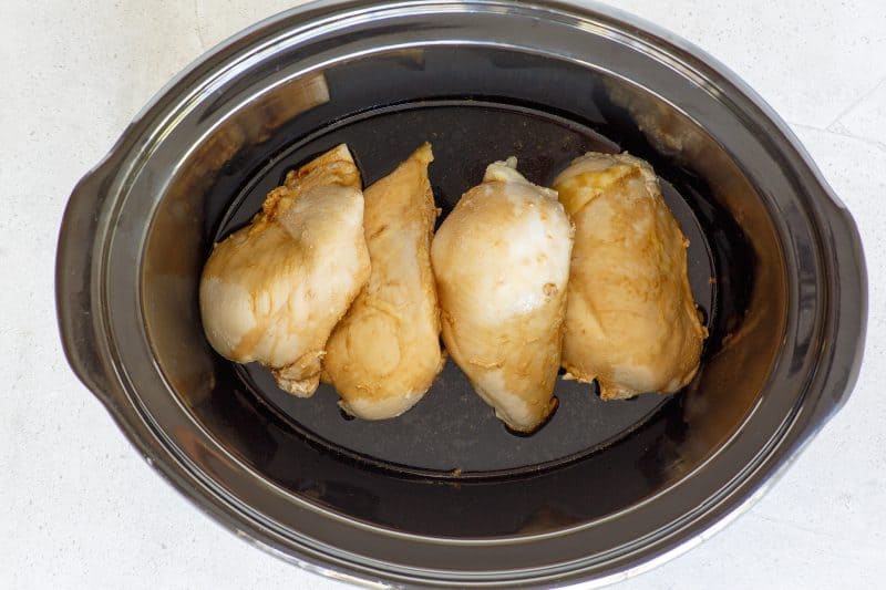 Mix ingredients together to make sauce and pour it over chicken breasts in the slow cooker.