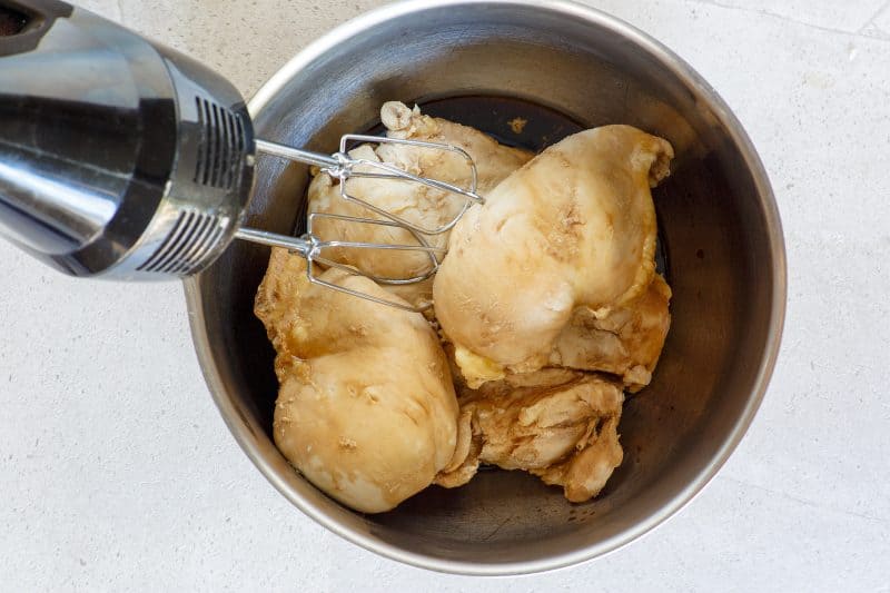 Shred chicken breast using electric mixer.