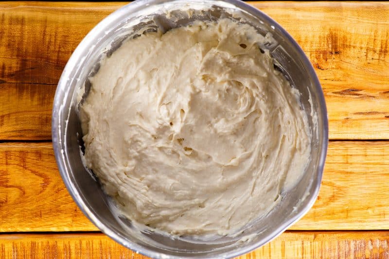 Beat together the cream cheese, white sugar, sour cream, and vanilla extract.