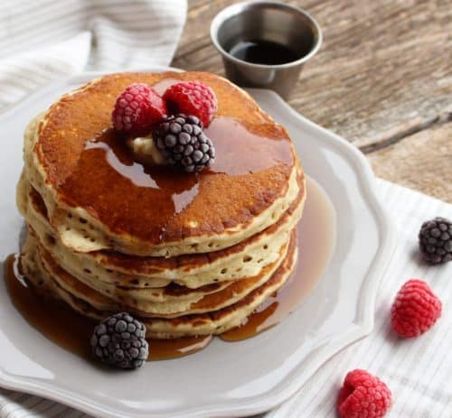 Pancakes with berries on white plate
