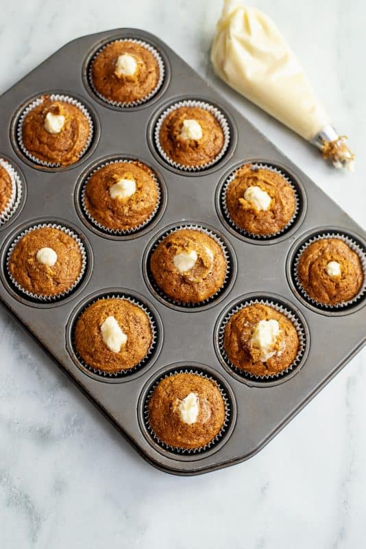 Pumpkin spice cupcake filled with cream cheese icing.