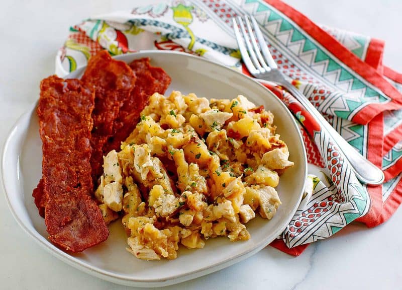 Bowl of turkey hash with crispy bacon.