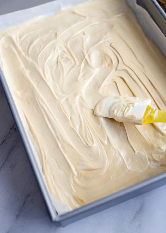 spreading chocolate in prepared pan.