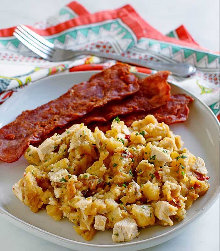 Plate of turkey hash with crispy bacon.