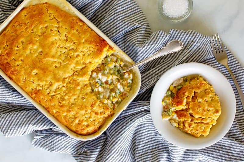 Cornbread chicken pot pie casserole and serving in a bowl.