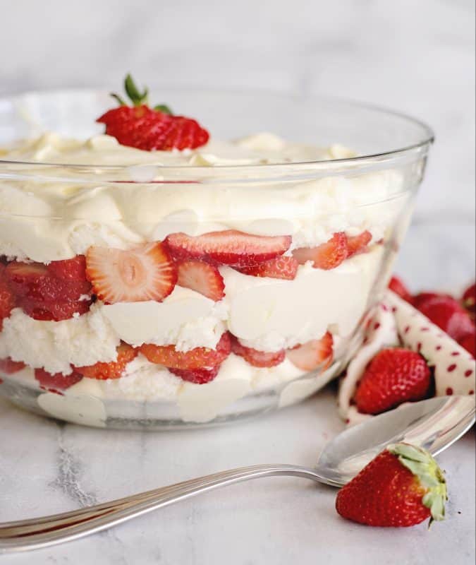Strawberry Punch Bowl Cake layered in a clear glass bowl