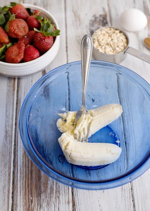 Mash banana in mixing bowl.