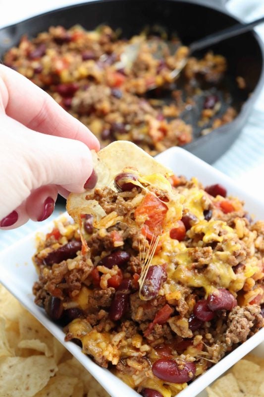 Tortilla chip covered in skillet chili bake.