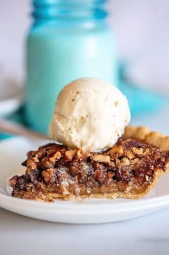 Scoop of ice cream on top of pie slice.