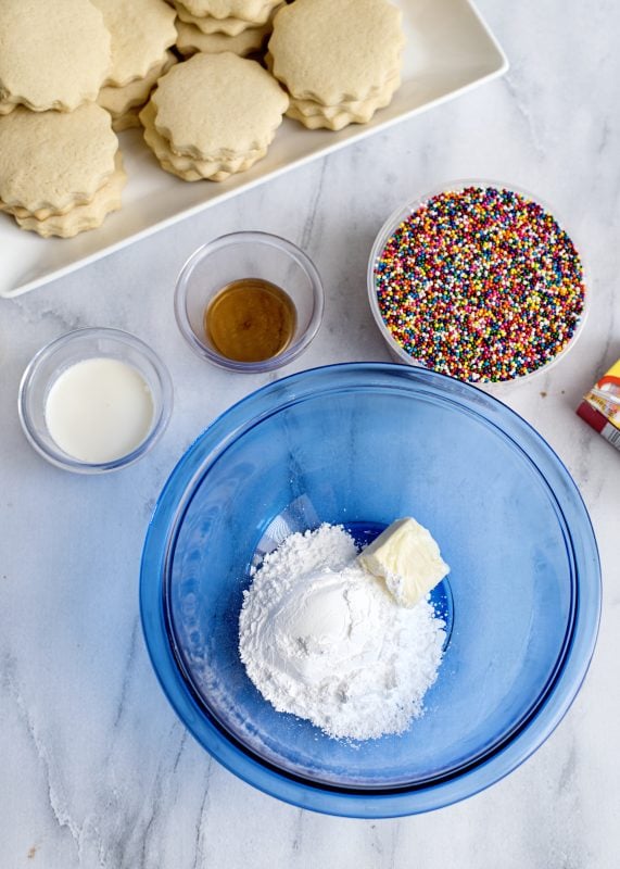 Cream together the butter and sugar in a bowl before adding milk and vanilla.